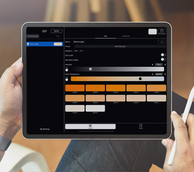 A person is holding a tablet showing the ERP LED light programming software on the screen.